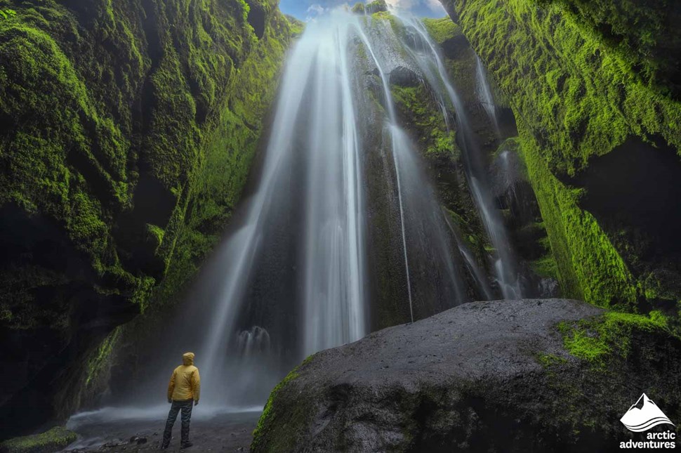 Man Looking at Hidden Waterfall in Iceland