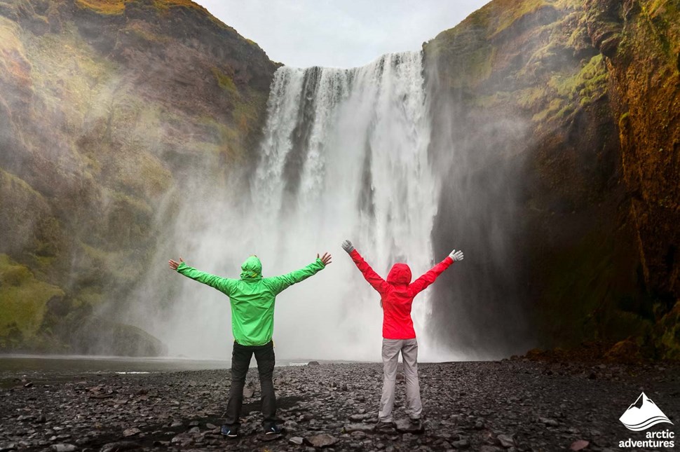 Couple Posing For Picture near Waterfall in Iceland