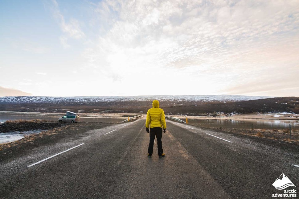 Man Standing on Road with Yellow Jacket