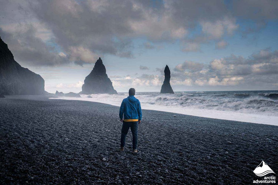 Man at Reynisfjara Black Sand Beach in Iceland