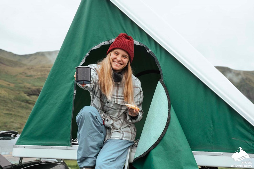 Woman Camping in Car Rooftop Tent