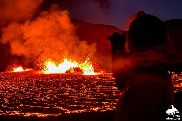 Woman Watching Volcano Eruption at Night