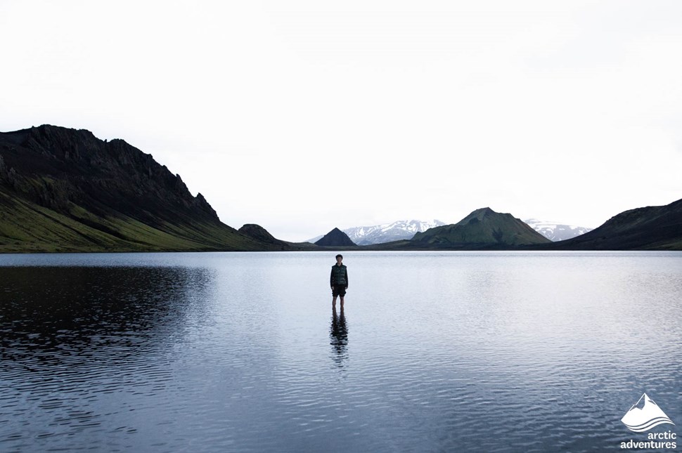 Man Stands in Lake in Iceland