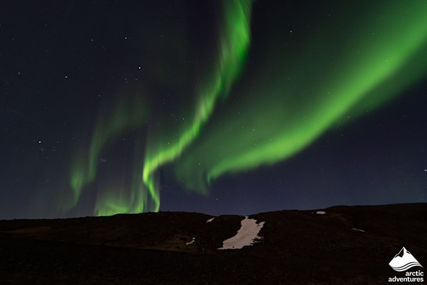 Bright Aurora over Hill in Iceland