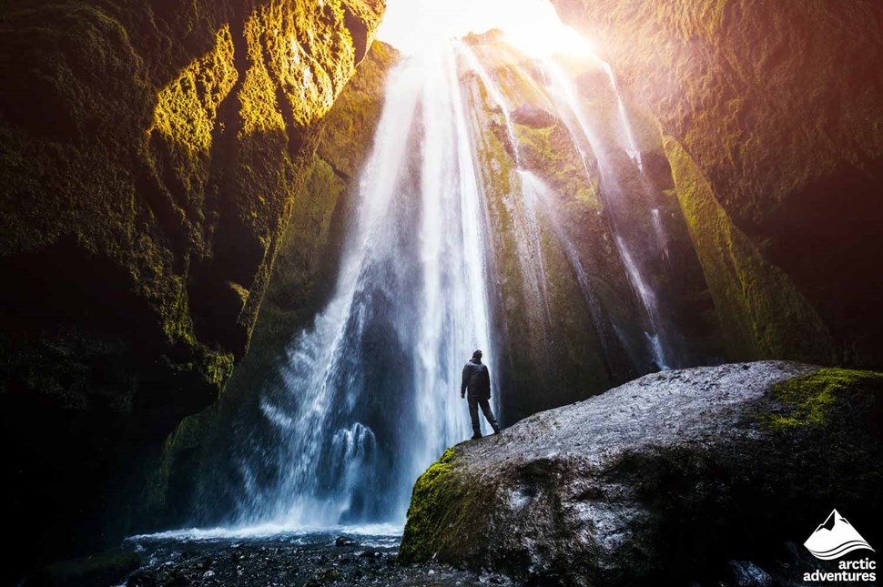 Man Standing by Gljufrabui Waterfall