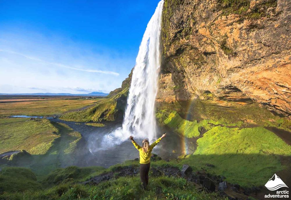 Excited Woman at Seljalandsfoss Waterfall 
