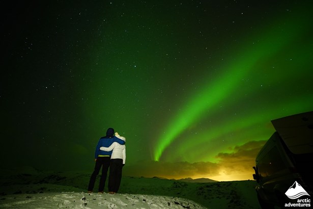 Couple Enjoying Northern Lights in Iceland