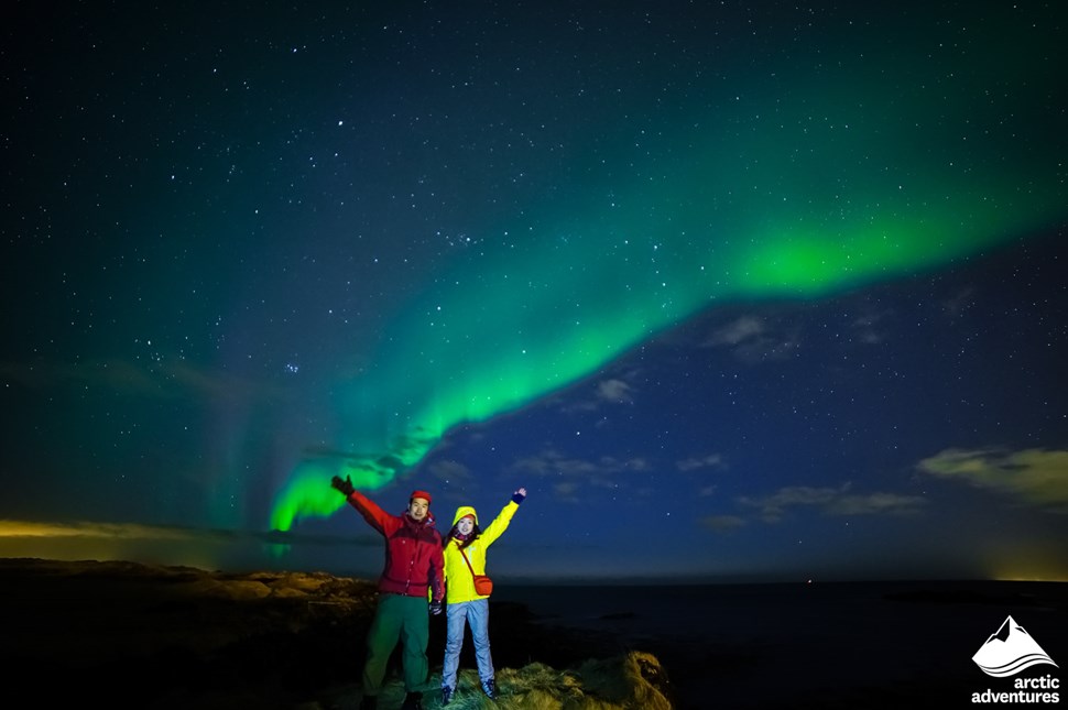 Happy Couple Watching Auroras in Iceland