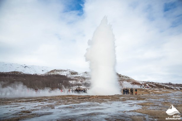 People Watching Geyser Eruption in Iceland