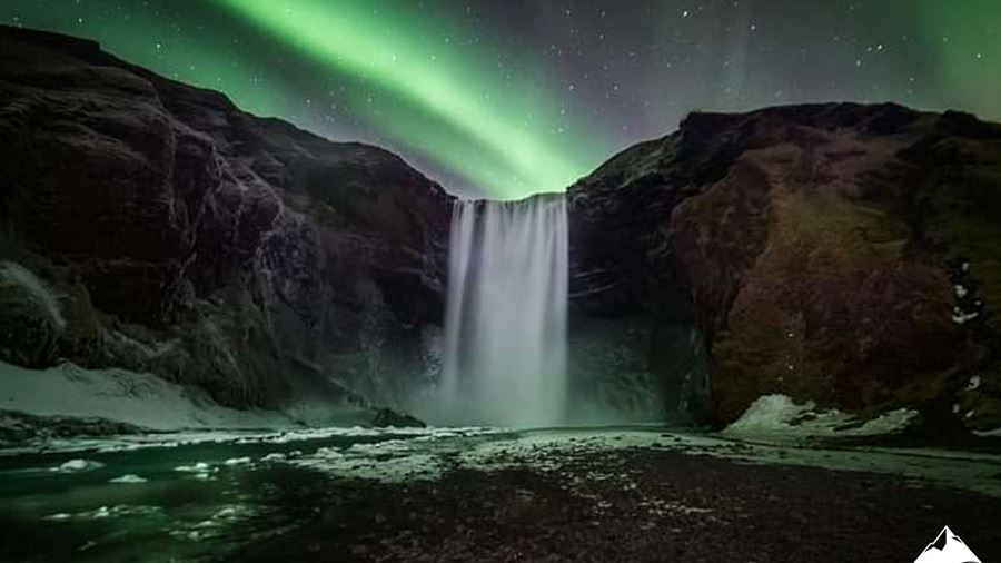 Northern Lights Over Waterfall