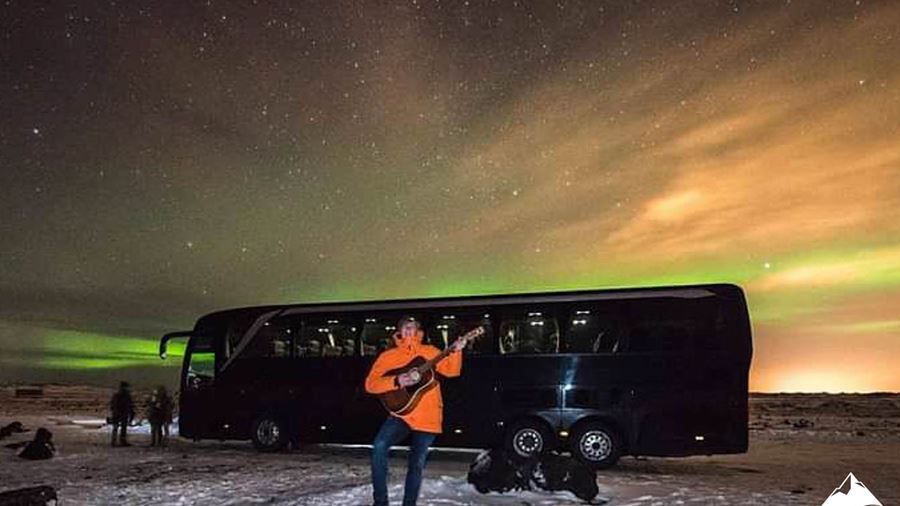Man Playing Guitar by the Auroras