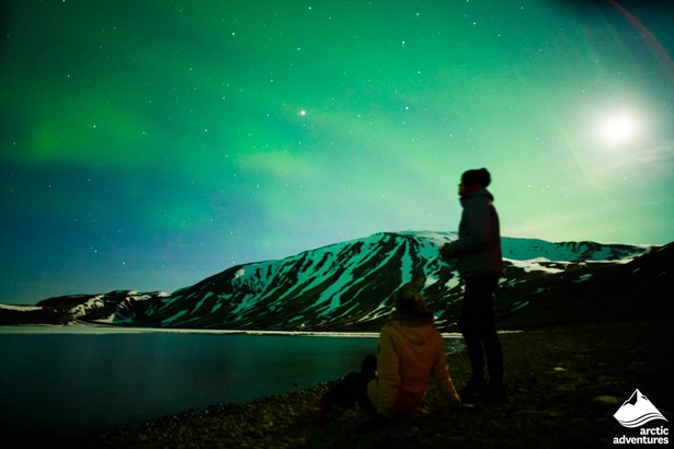 Friends Watching Aurora by the Lake in Iceland