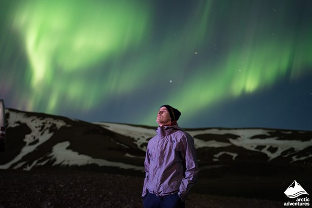 Man Looking at Aurora in Sky