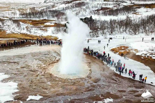 People Watching Erupting Geyser in Iceland