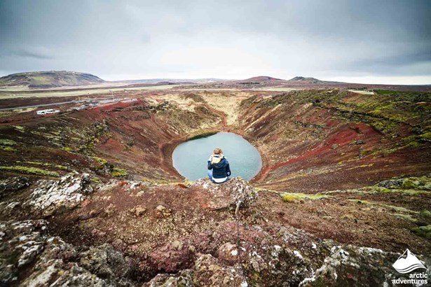 Woman Sitting by Kerid Crater in Iceland