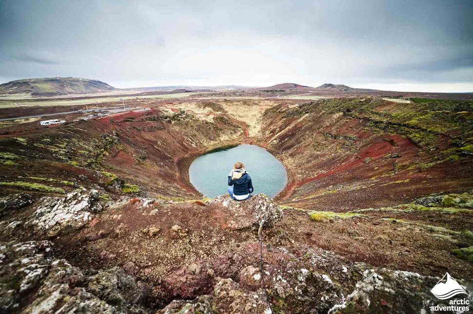 Woman Sitting by Kerid Crater in Iceland