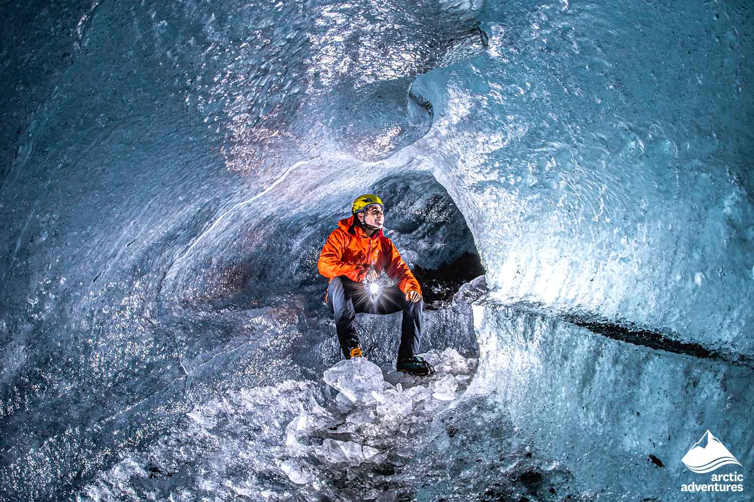 Guide Sitting in Ice Cave of Glacier