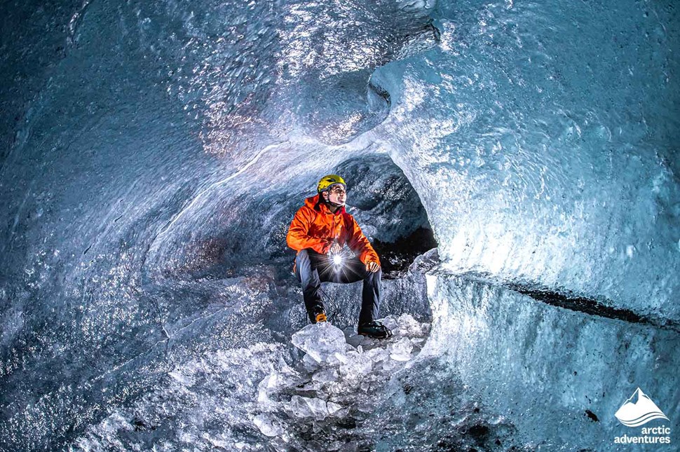 Guide Sitting in Ice Cave of Glacier