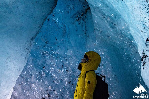 Woman with Yellow Jacket Inside of Ice Cave