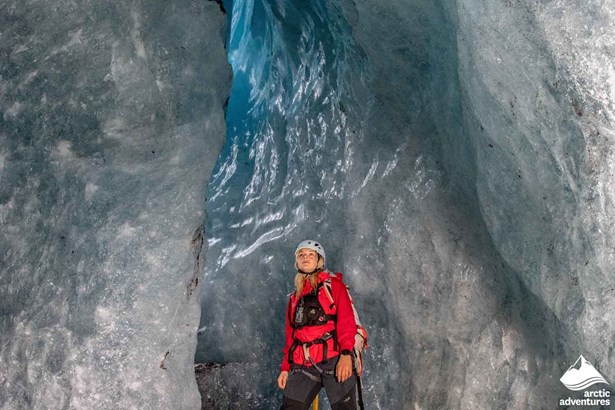 Glacier Guide with Red Jacket in Ice Cave