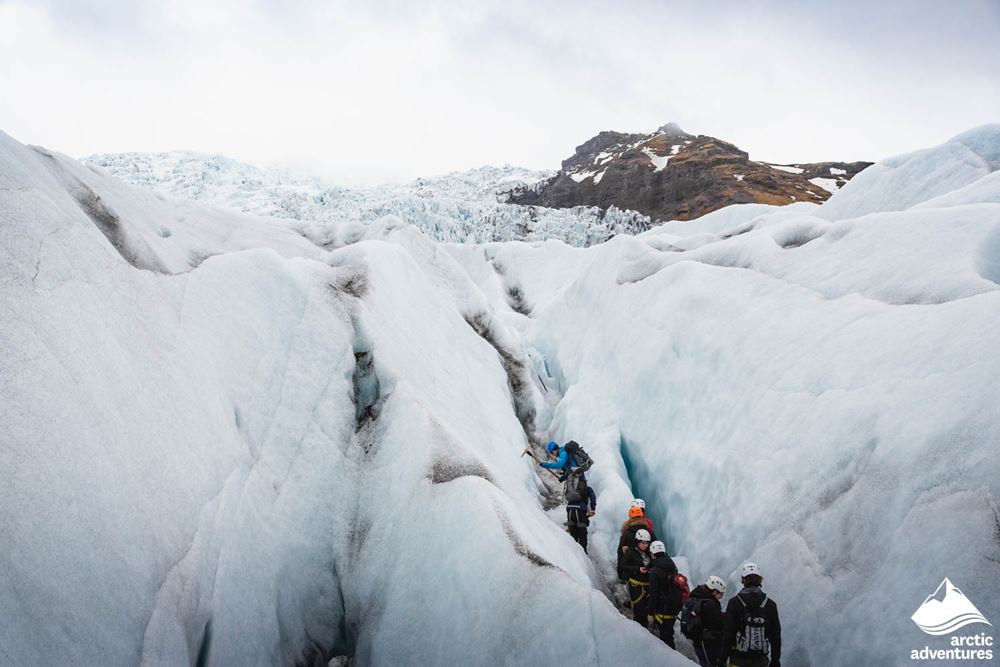 People Walking in Glacier Crevasses