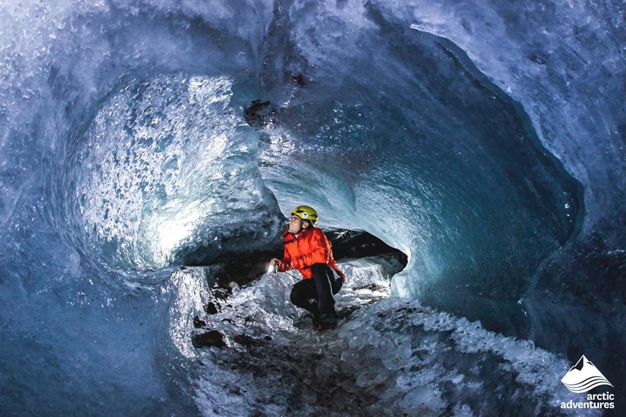 Man Inside Ice Cave on Glacier