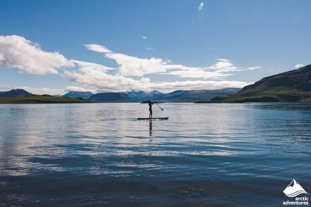 Woman Paddle Boarding in Icelandic Ocean