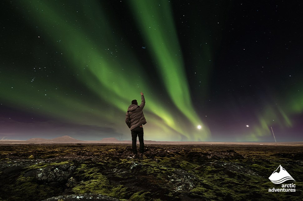 Man Watching Green Northern Lights in Iceland