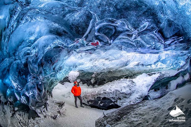 Man with Red Jacket in Ice Cave Iceland
