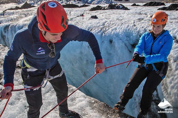 Guide Helping to Ice Climb on Glacier
