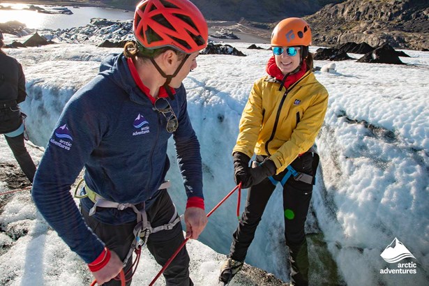 Woman Climbing on Ice with Guide