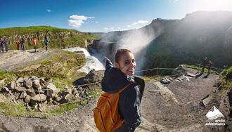 Happy Woman by Gullfoss Waterfall in Iceland