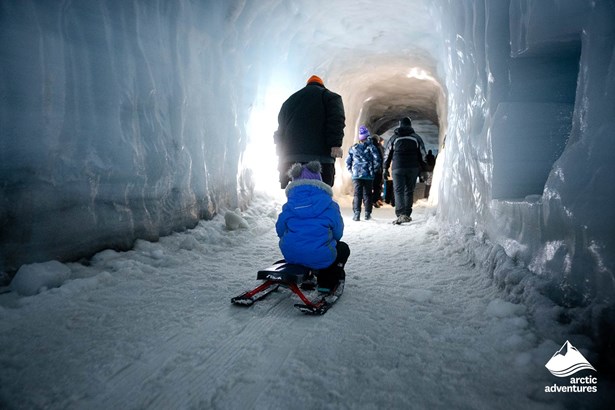 People Walking Inside Ice Tunnel in Iceland