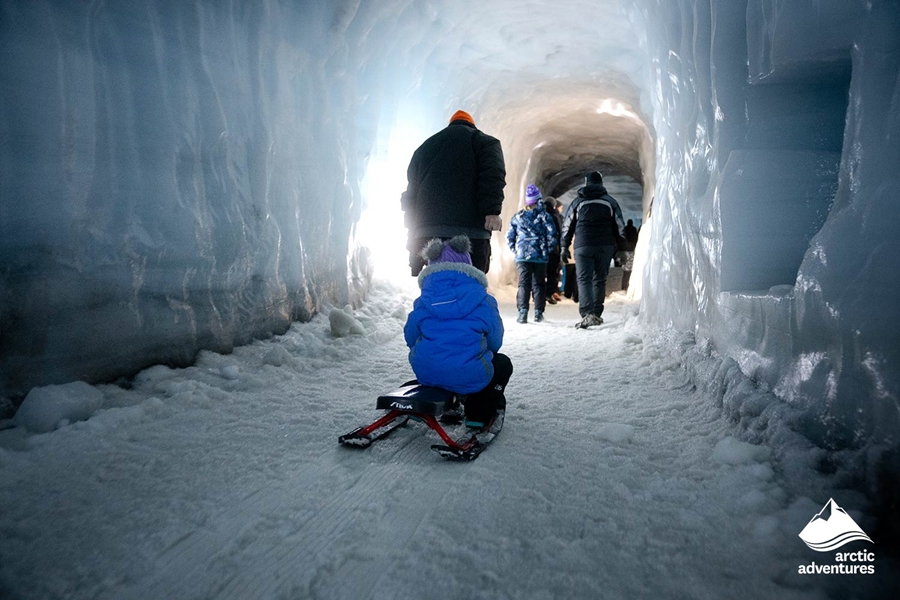 People Walking Inside Ice Tunnel
