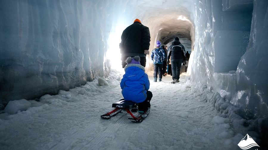 People Walking Inside Ice Tunnel
