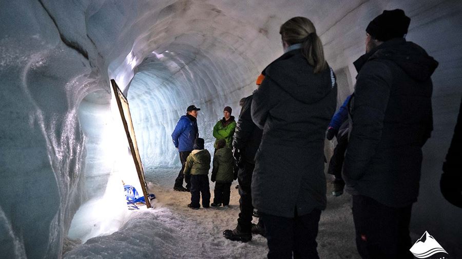 Tour Guide with Group in Ice Tunnel