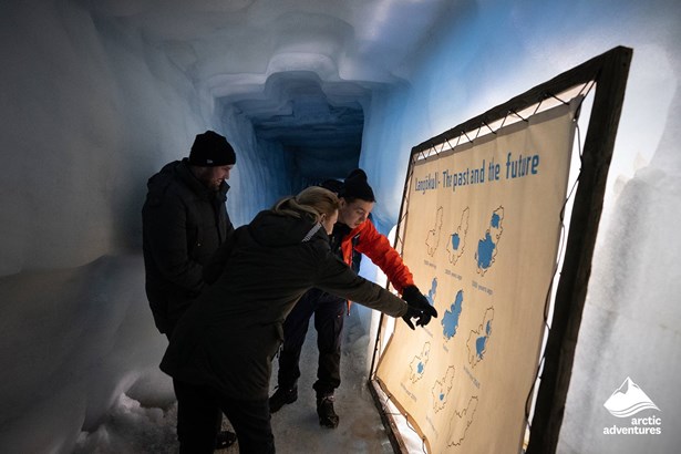 People Looking at Map in Ice Tunnel