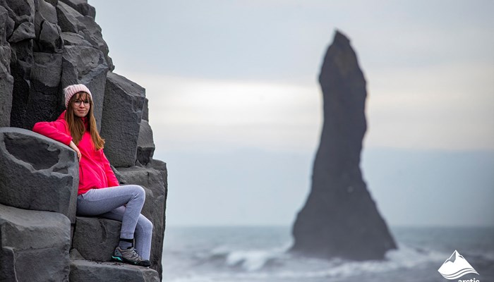 Girl Sitting on Basalt Columns in Iceland