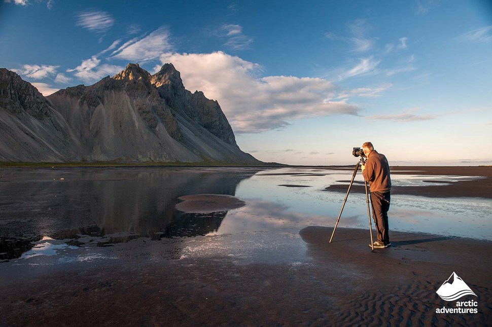 Man Photographing Mountain in Stokksnes