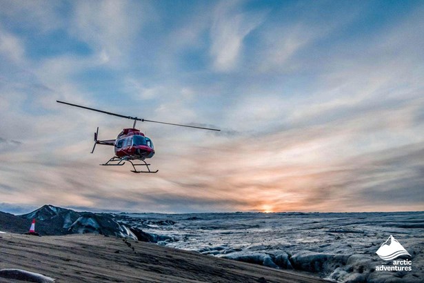 Helicopter Flying by Glacier in Iceland