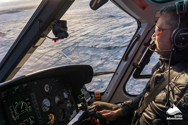 Pilot Flies Helicopter Over Glacier