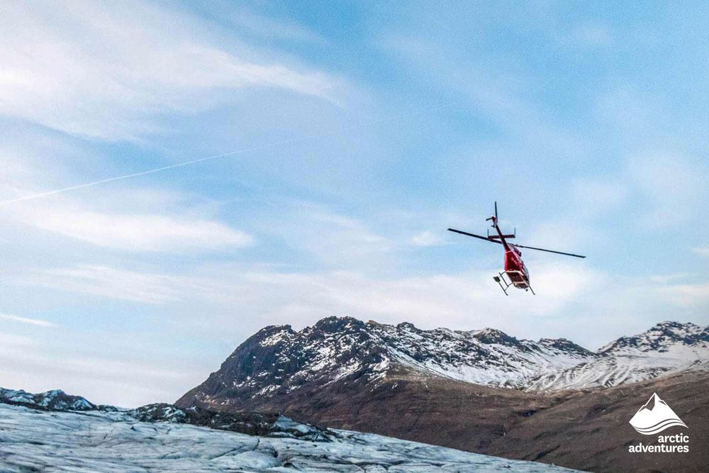 Helicopter Flying Over Glacier