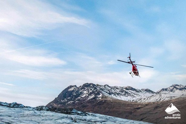 Helicopter Flying Over Glacier in Iceland