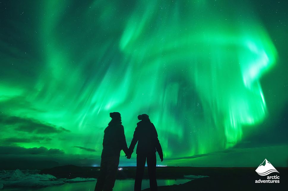 Couple Looking at Northern Lights in Sky