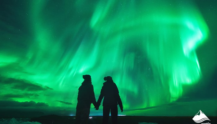 Couple Looking at Northern Lights in Sky