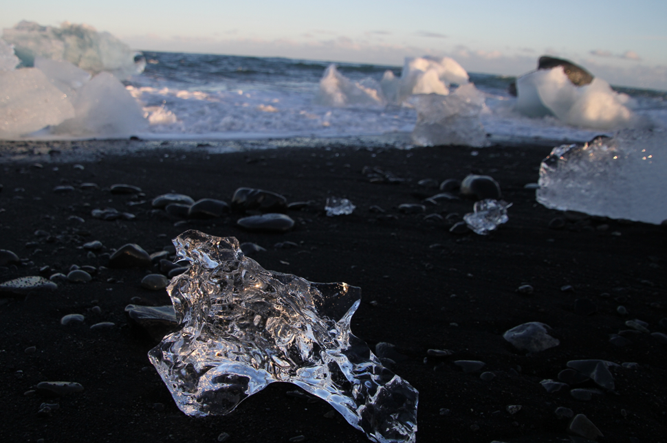 Crystal Clear and Blue Ice Floes on a Black Sand In Iceland