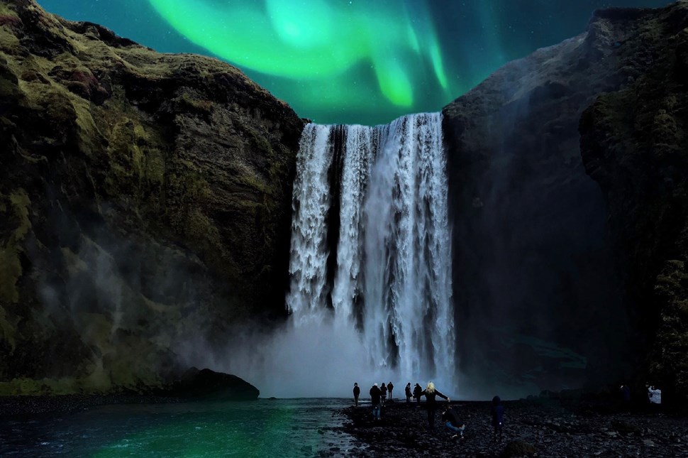 Green and blue Northern Lights above the Skogafoss Waterfall Iceland