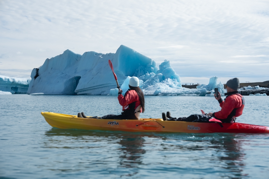 Couple in Kayak near Iceberg