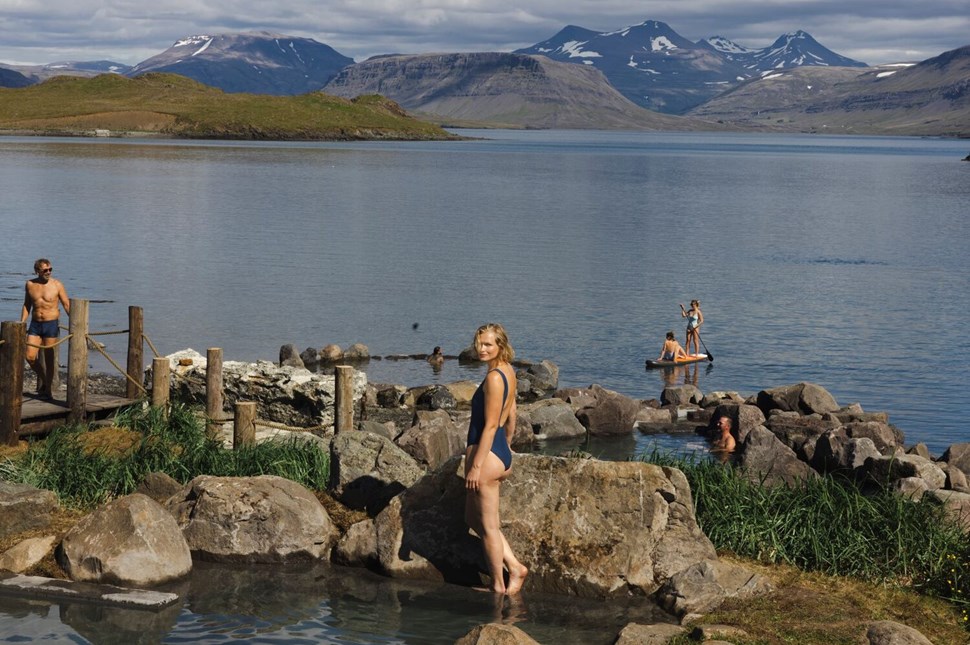People Standing On Rocks In Hvammsvik Hot Springs