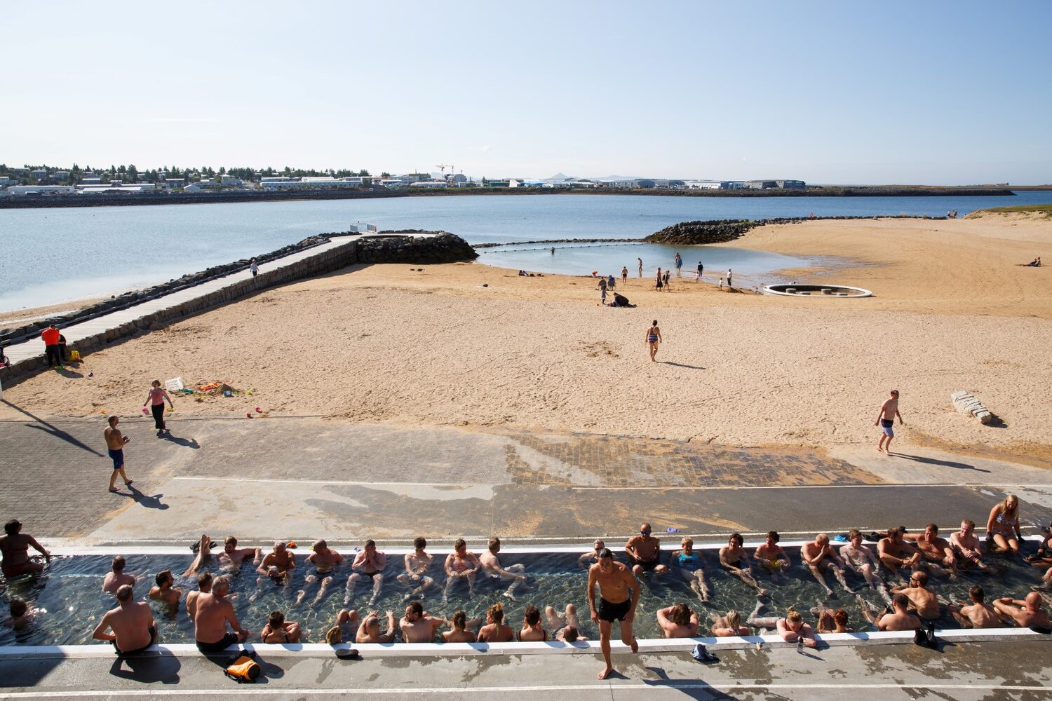 People At Nautholsvik Geothermal Beach Iceland Golden Sand